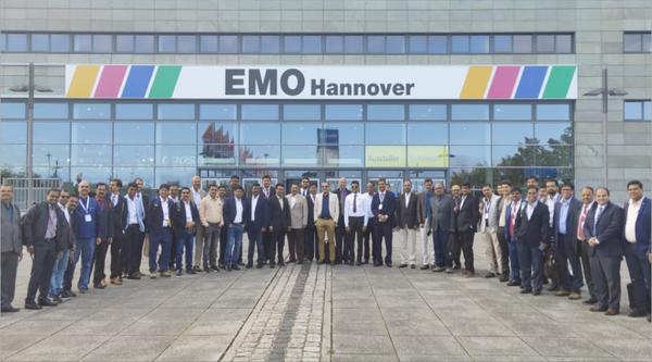 Group of people poses in front of an emo-themed Hanover building.