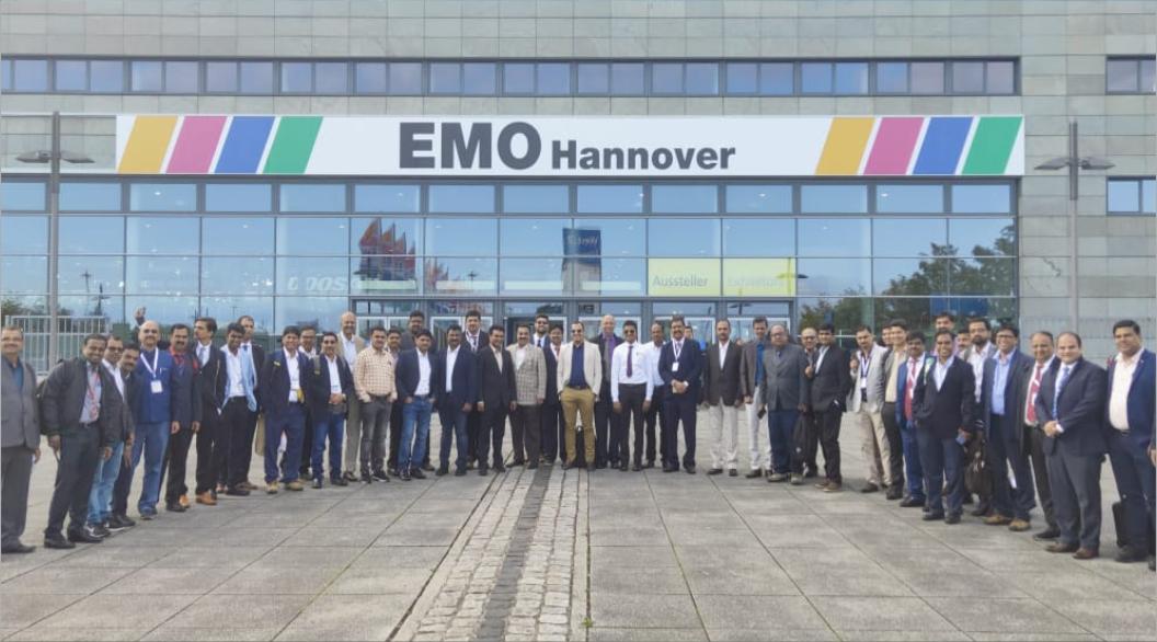 Group of people poses in front of an emo-themed Hanover building.
