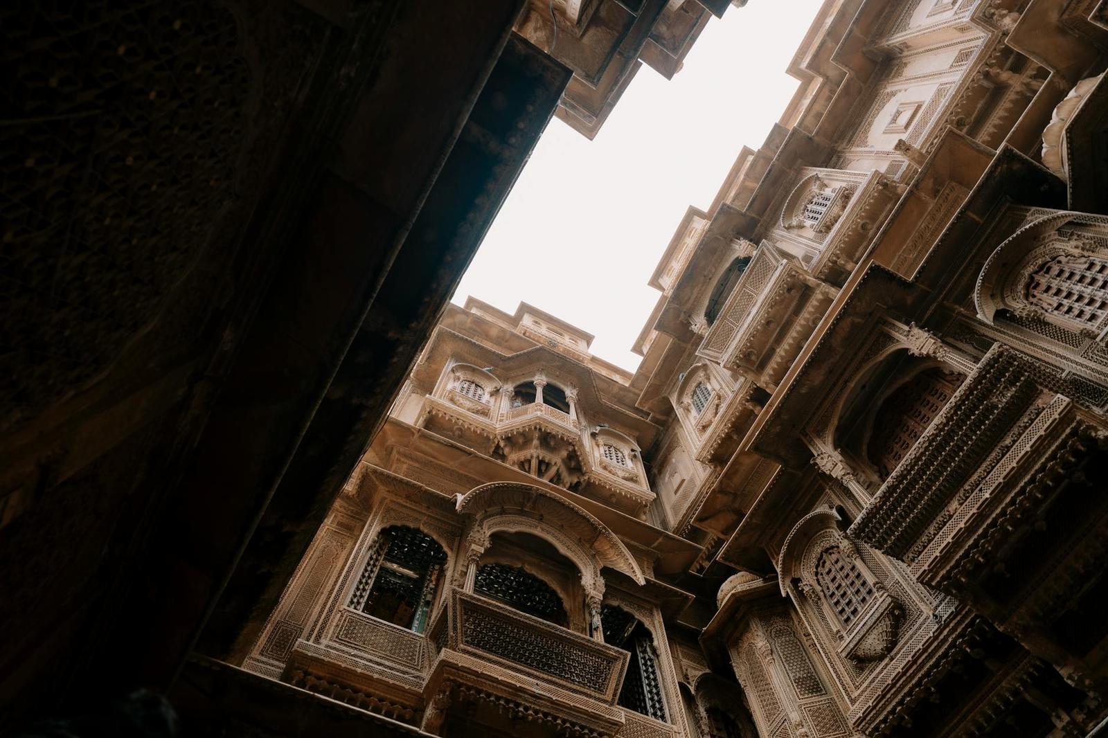 Low-angle view of intricately carved architecture in a historic Jaisalmer haveli