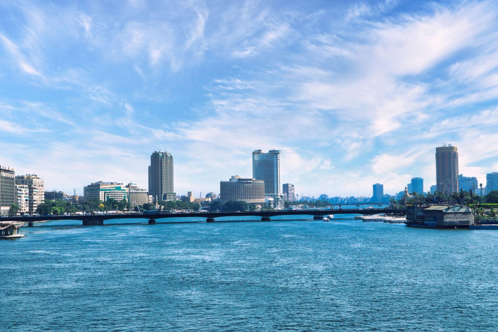 Discover the stunning Cairo skyline with the serene Nile River and a clear blue sky backdrop