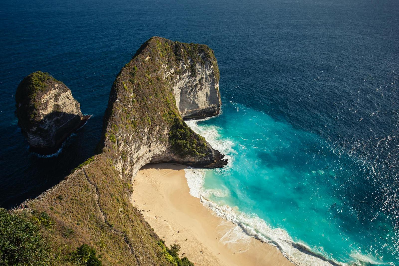 A jagged cliff shaped like an animal's head above a turquoise cove