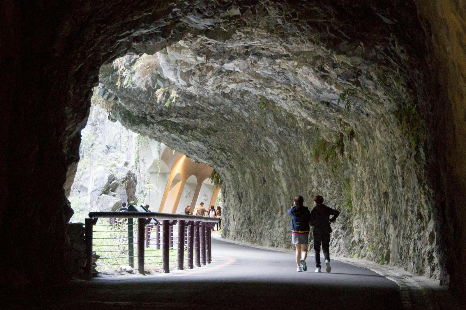 Tourists explore the scenic Shakadang Trail tunnel in Taroko National Park, Taiwan