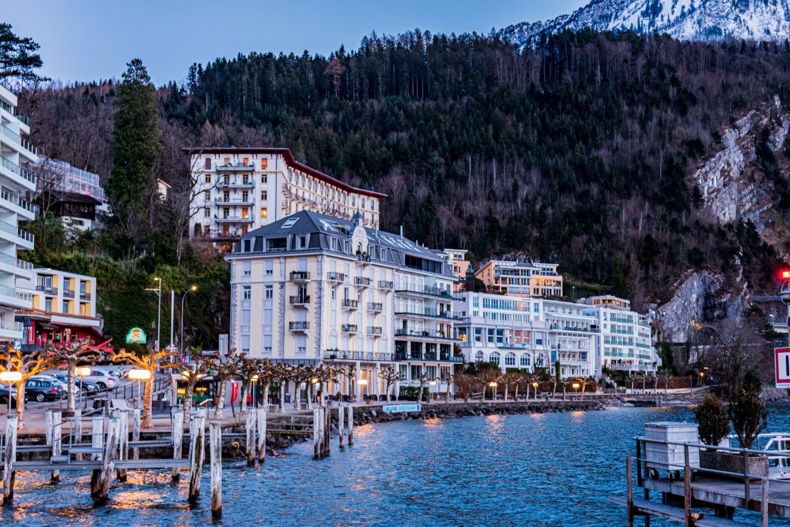Elegant waterfront buildings along Lake Lucerne in Ingenbohl, Switzerland, with scenic mountain backdrop