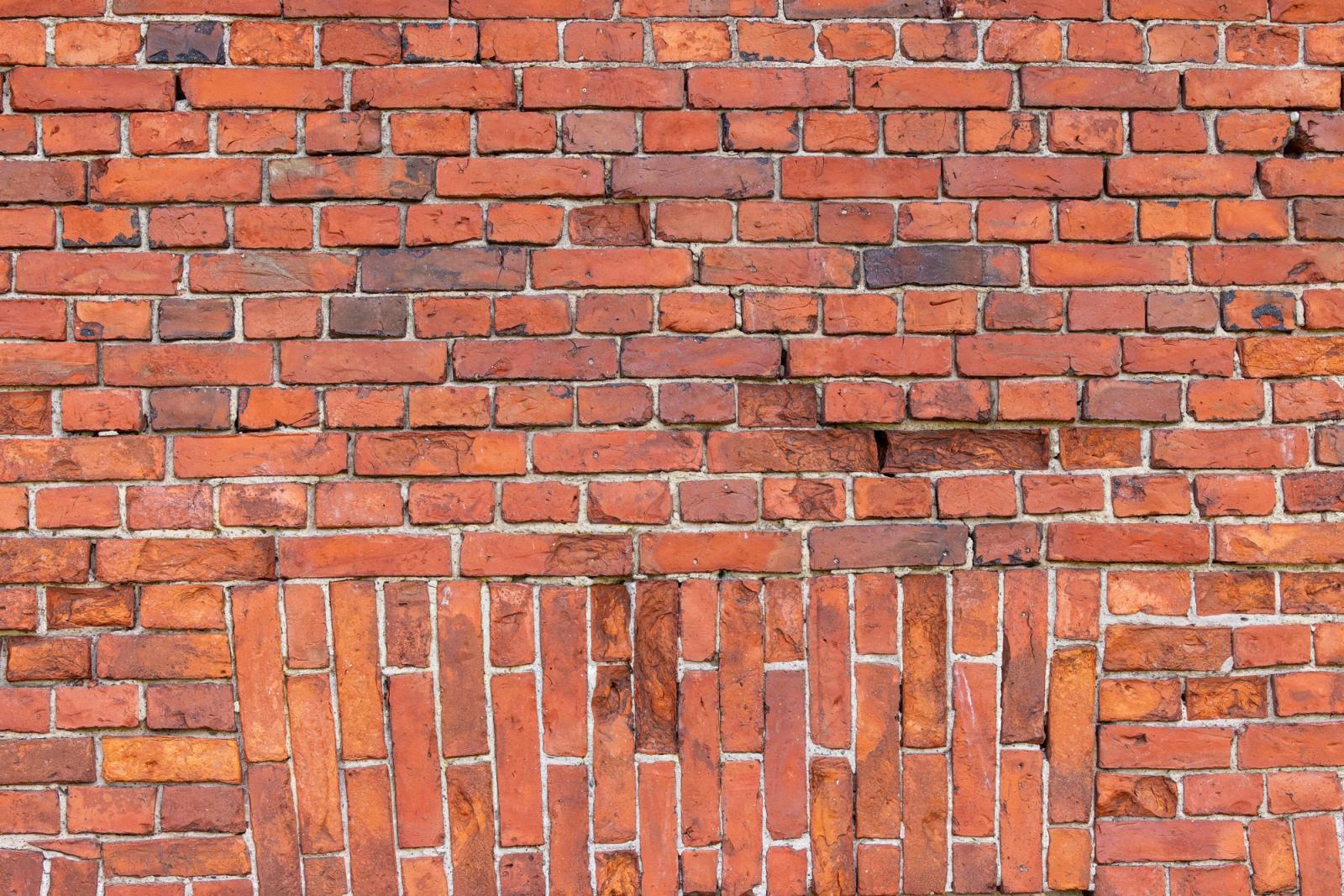 Close-up view of a red brick wall with distinct patterns, showcasing Helsinki's classic architecture style