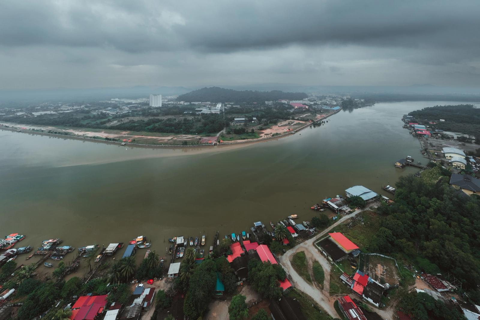 Aerial photograph of the Chukai River and surrounding landscape in Terengganu, Malaysia under cloudy skies