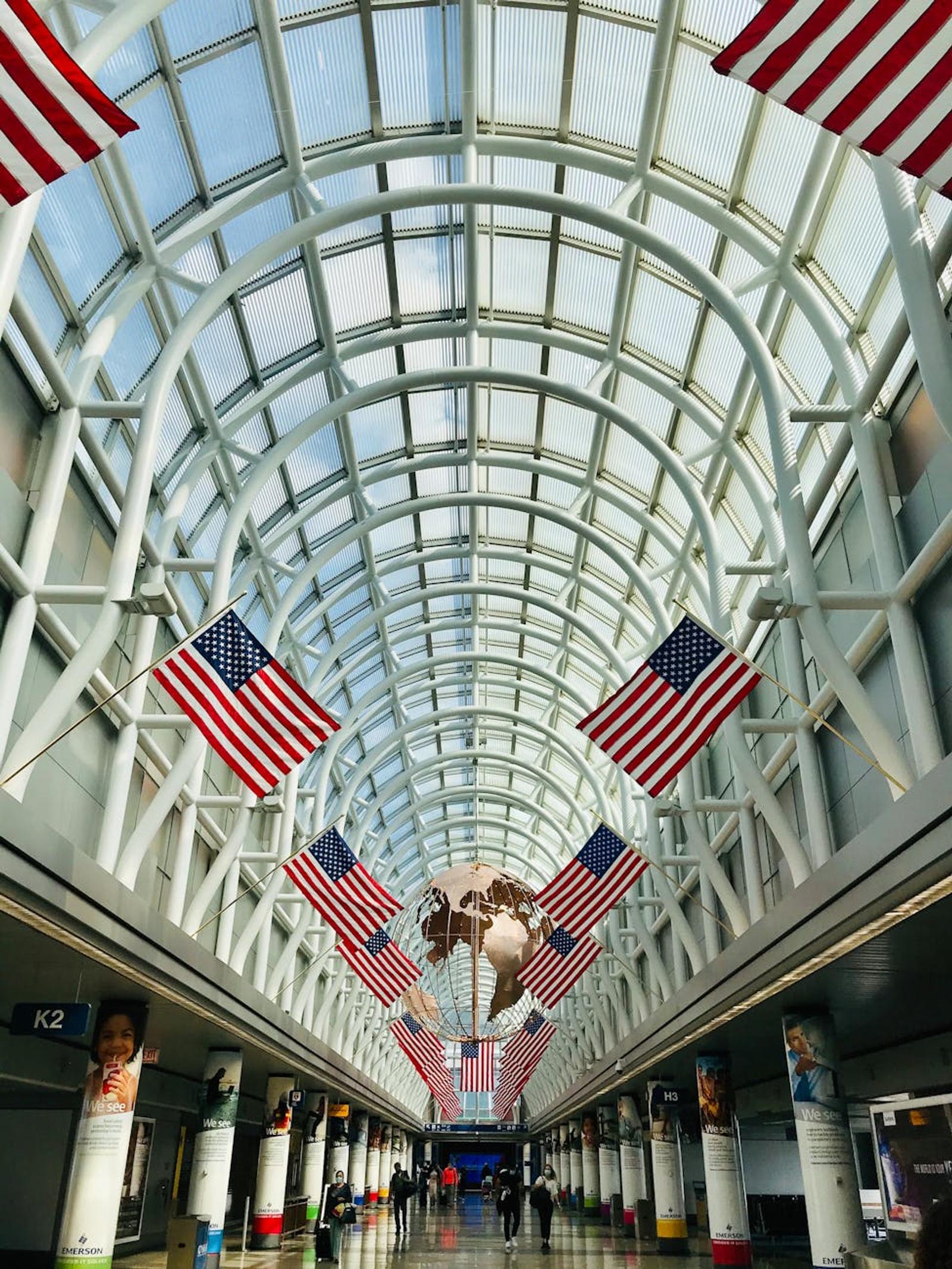Interior of Chicago O'Hare Airport with American flags and globe sculpture