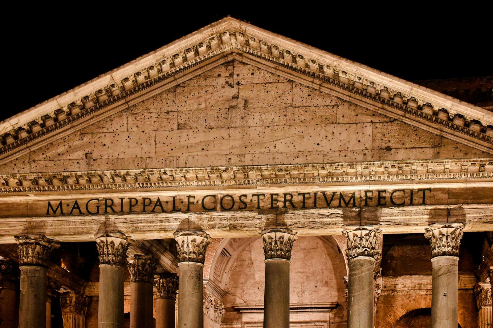 The Pantheon's inscribed pediment and Corinthian columns lit up at night