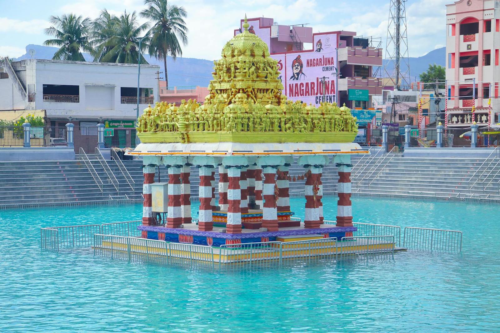 Colorful temple pavilion in a reflecting pool with traditional architecture