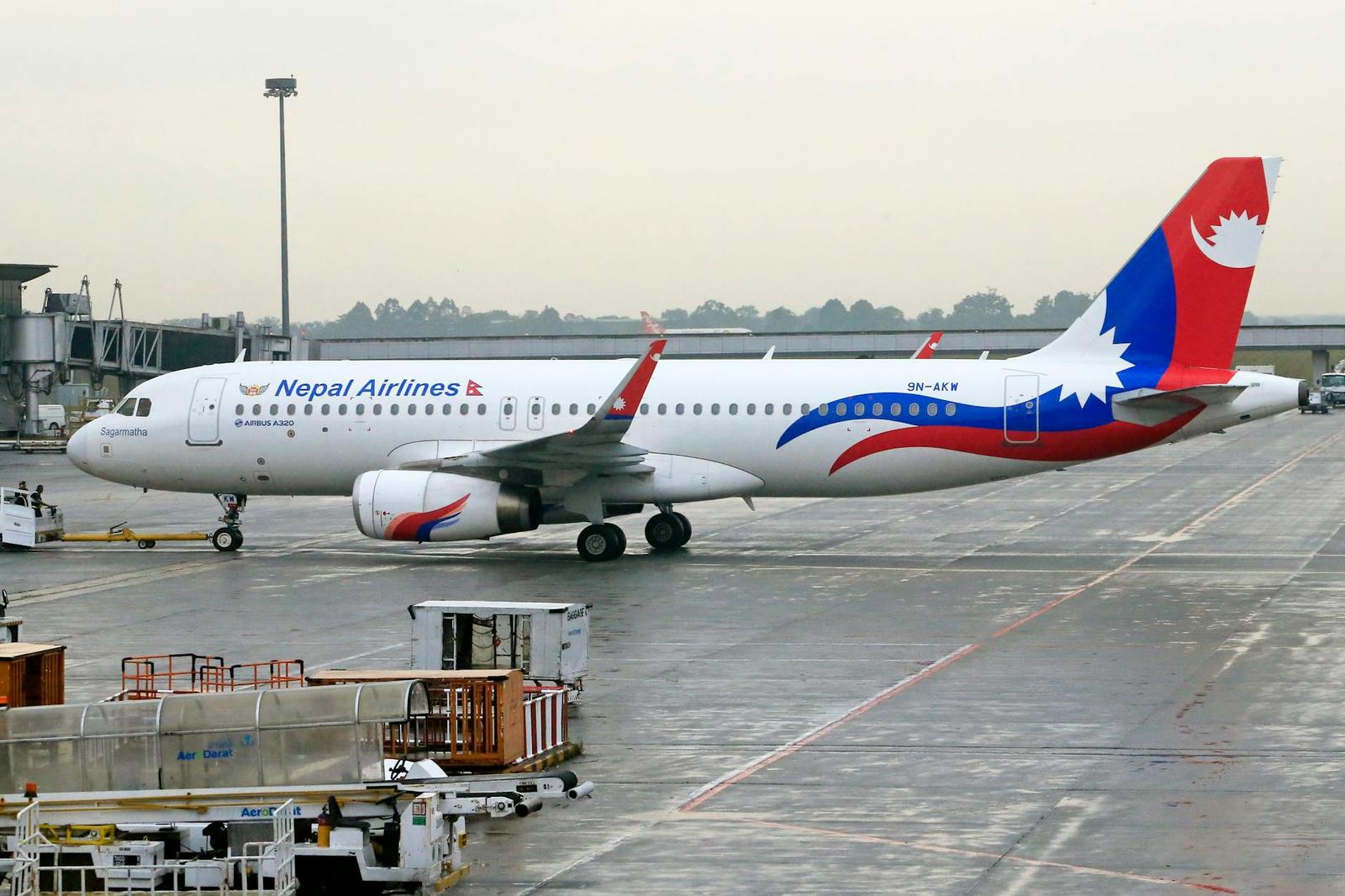 A commercial airliner in national livery taxiing on an airport tarmac