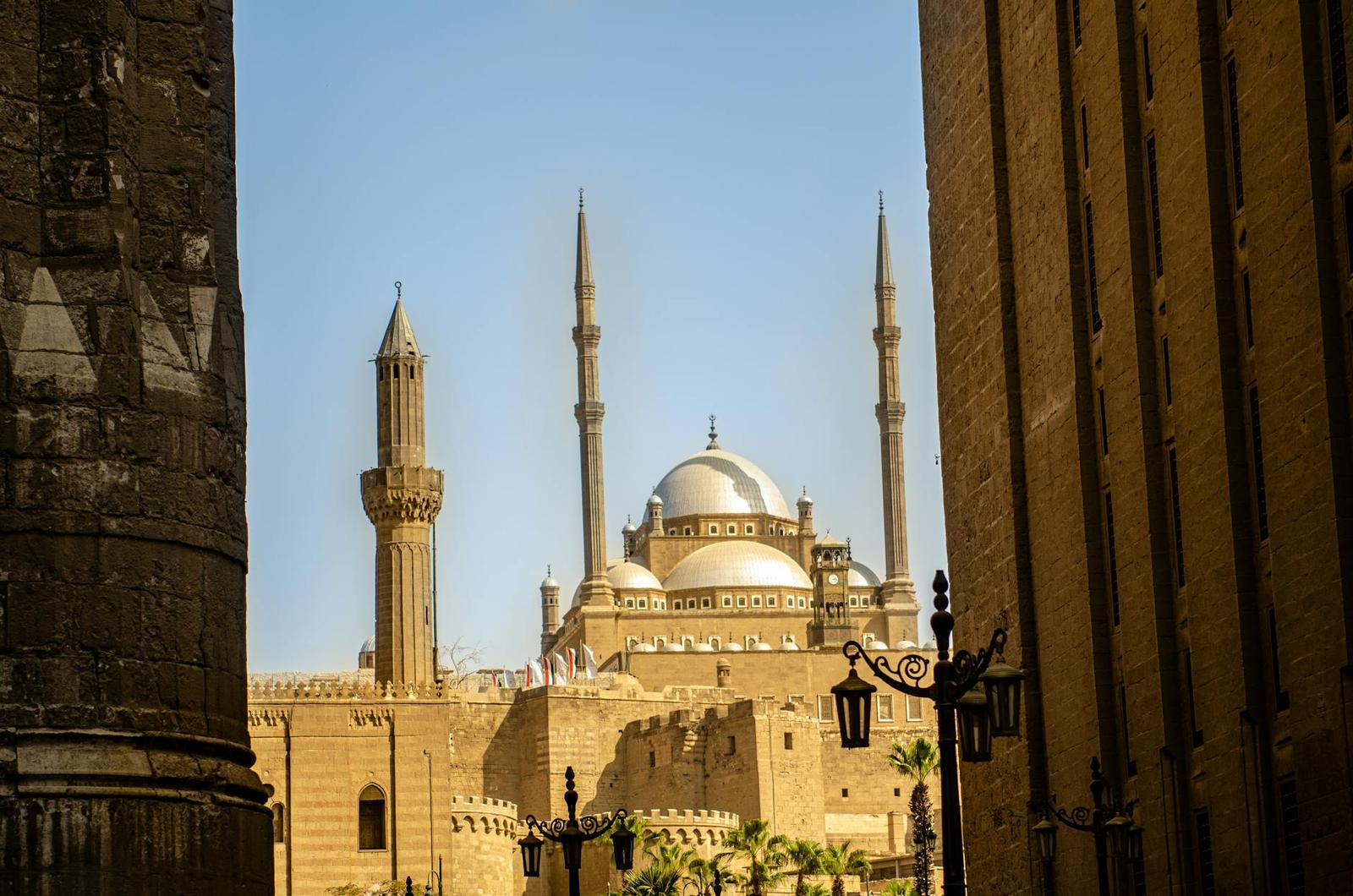 A stunning view of a mosque in Cairo featuring elegant minarets and a dome roof