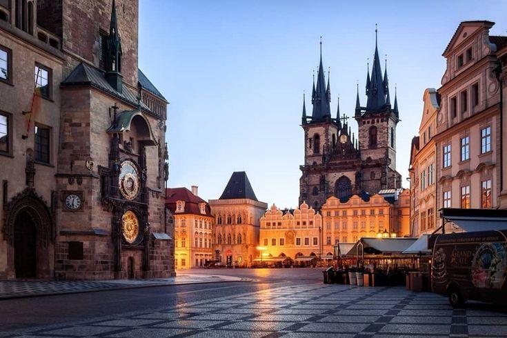 Prague's old-town spires and Charles Bridge over the Vltava at dusk