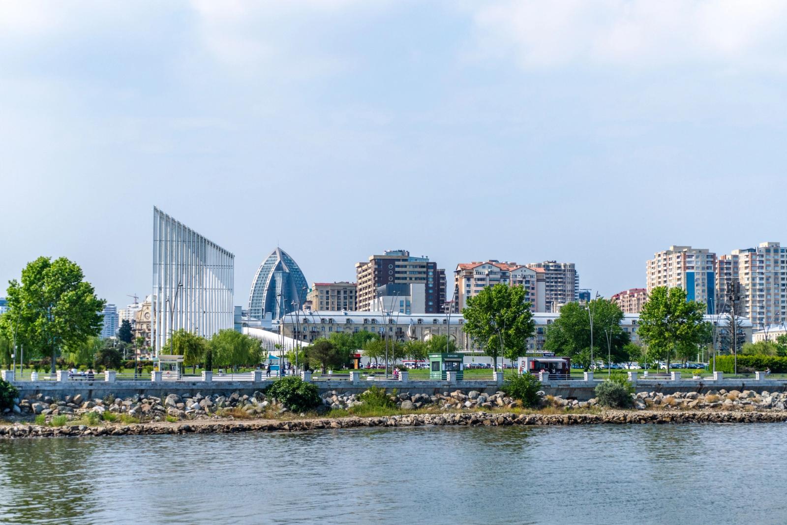 Stunning view of Baku skyline featuring modern architecture and lush greenery along the waterfront