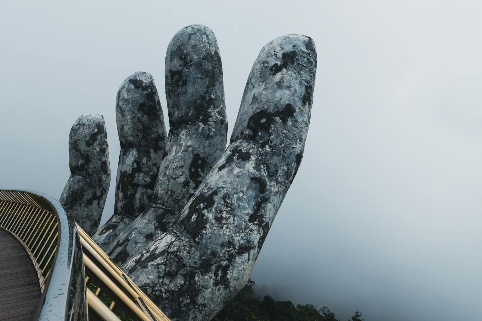Captivating view of the Golden Hand Bridge enveloped in mist in Da Nang, Vietnam's scenic landscape
