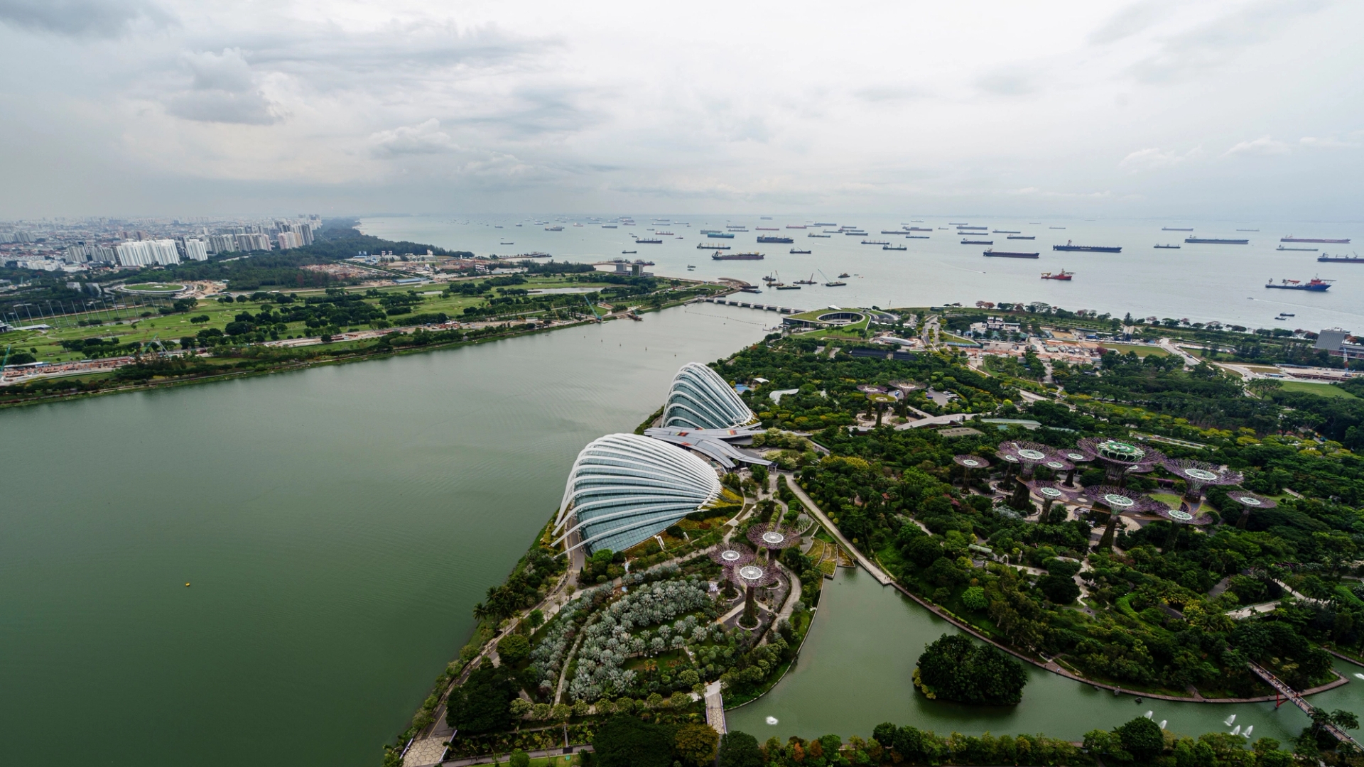 Aerial shot of Marina Bay with lush gardens and coastal waters, Singapore skyline