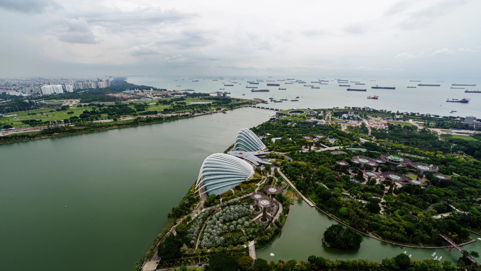 Aerial shot of Marina Bay with lush gardens and coastal waters, Singapore skyline