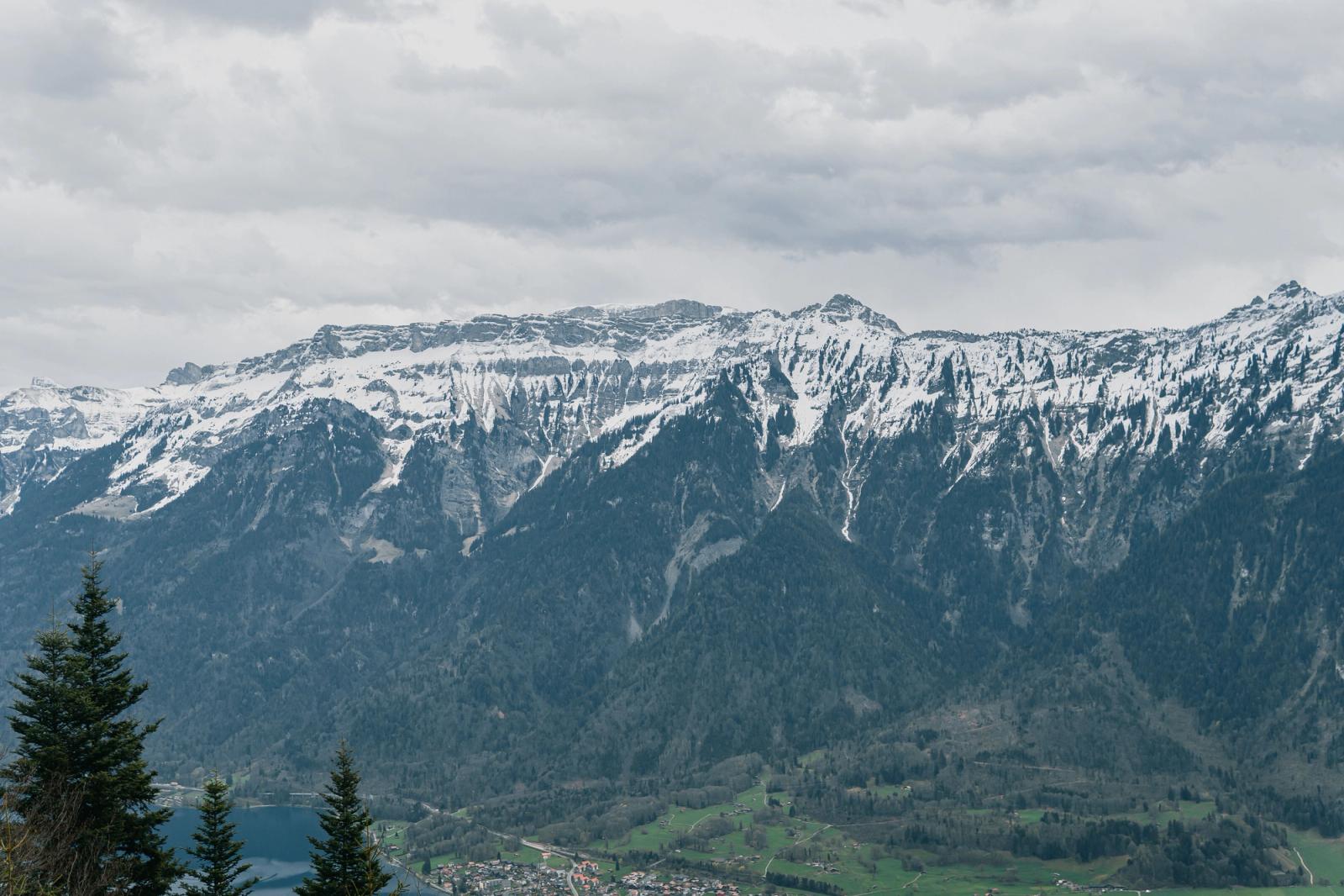 Spectacular view of snow-covered mountains in Interlaken, Switzerland, captured on a cloudy day