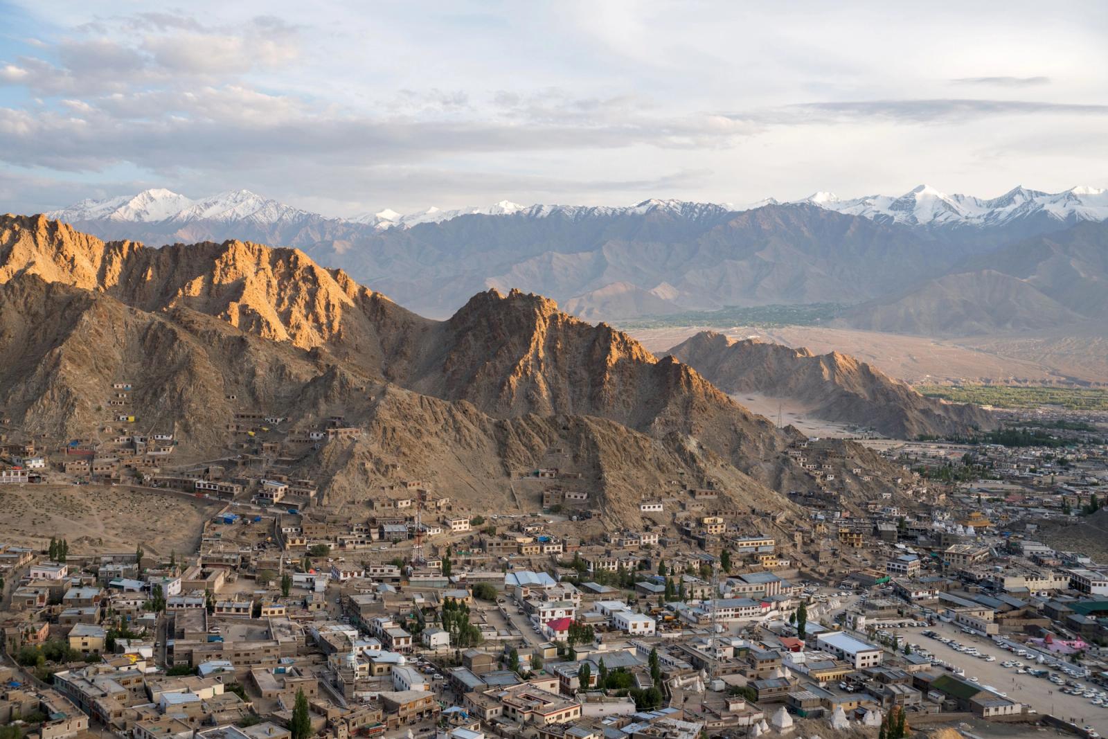 A breathtaking aerial view of Leh city surrounded by majestic snowcapped mountains