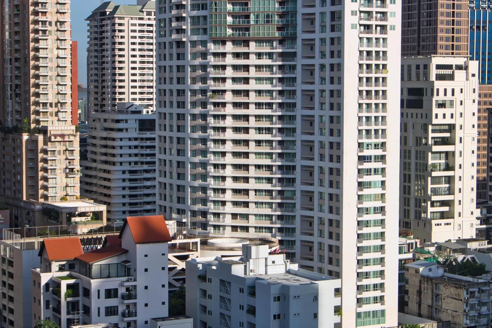 A cityscape view of modern skyscrapers and buildings in Bangkok, Thailand, showcasing urban architecture