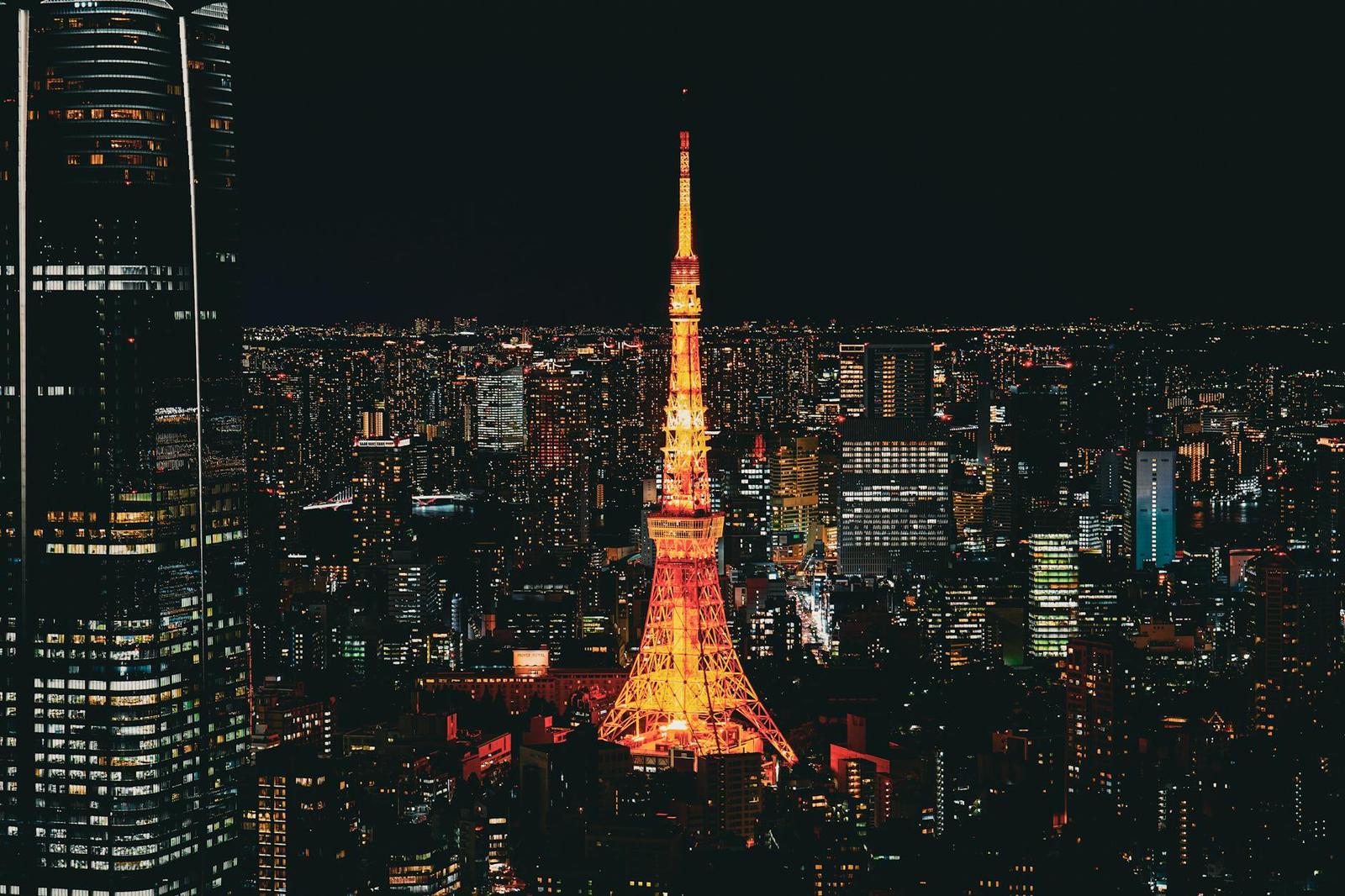 Tokyo Tower lit up orange amid a sea of city lights at night