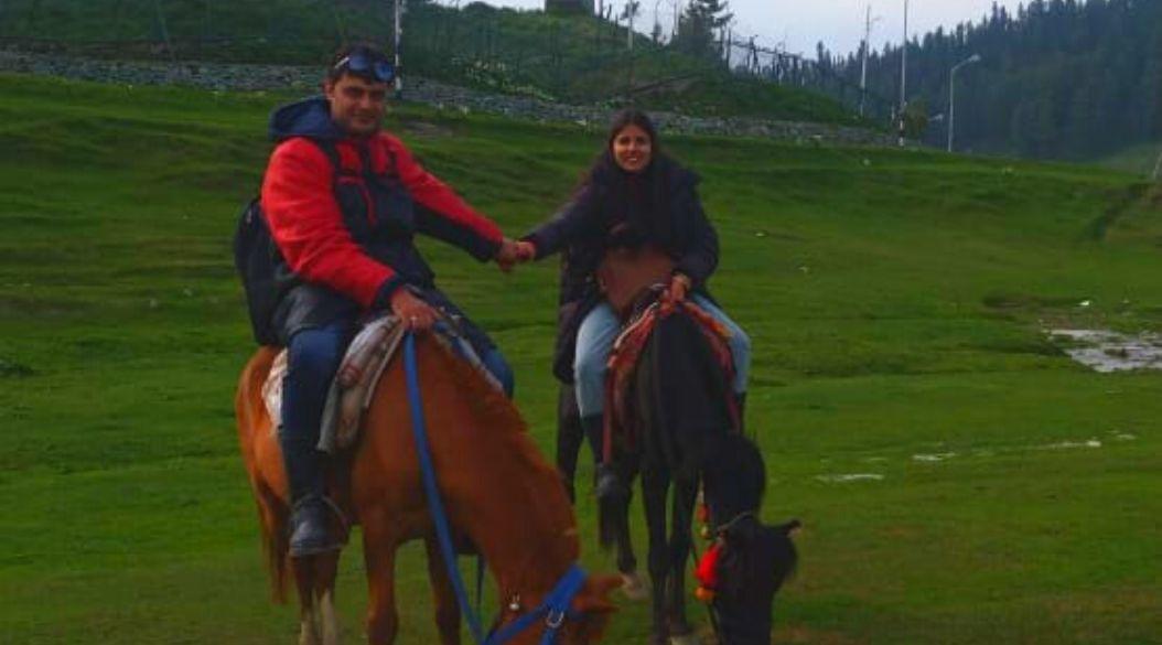 Two people riding a horse