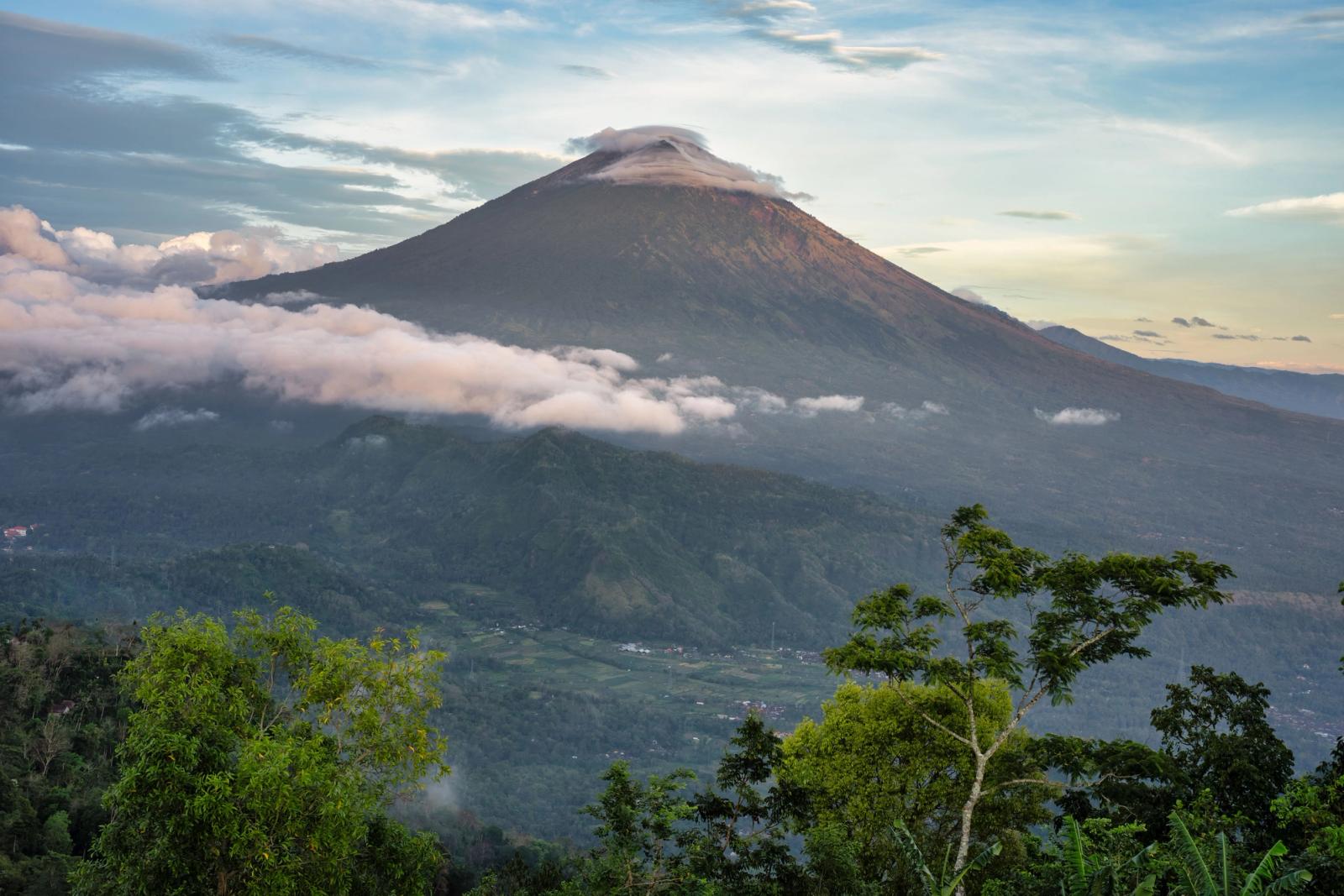 Stunning view of Mount Agung surrounded by clouds and lush greenery in Bali, Indonesia