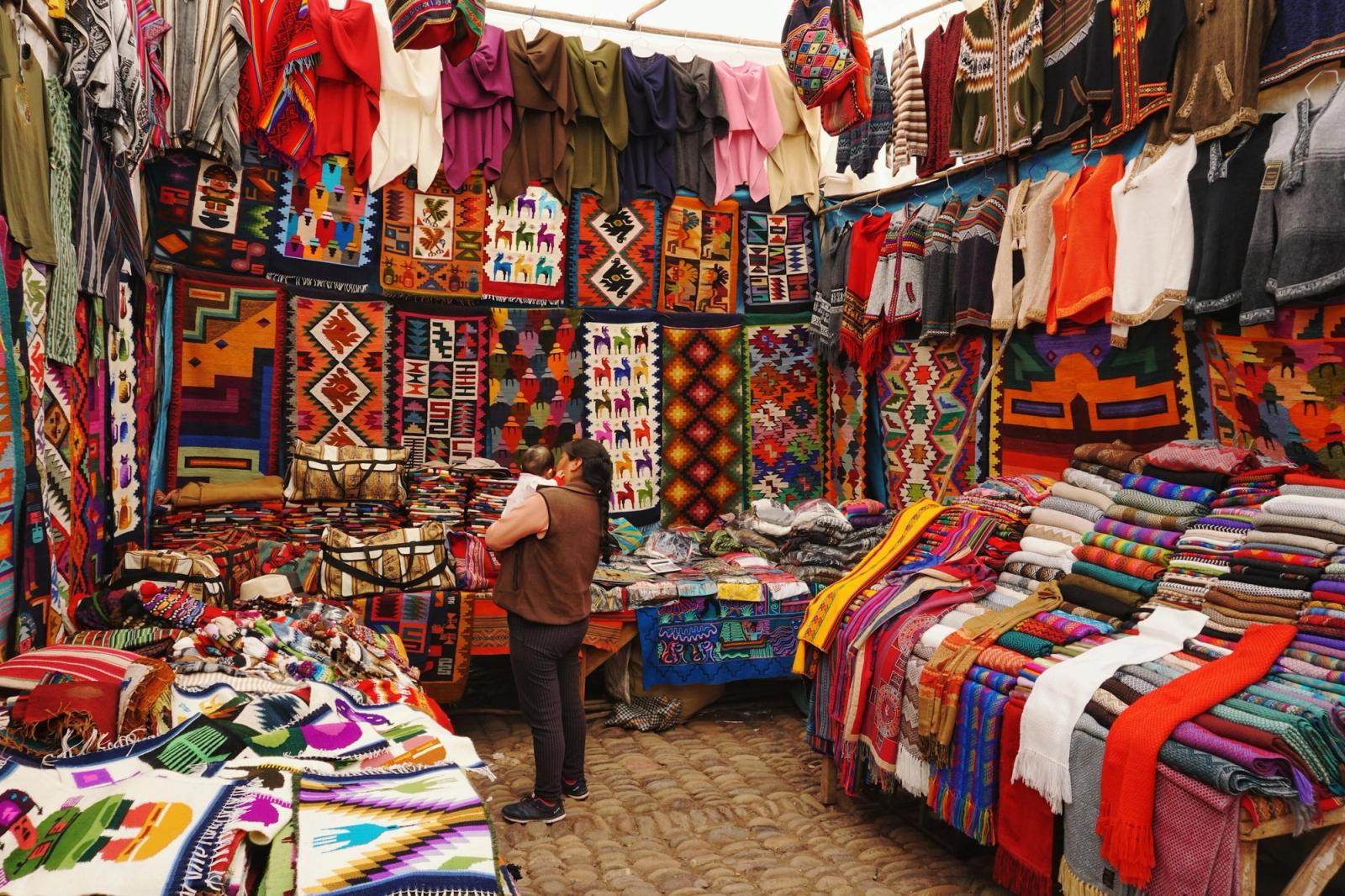 Pisac market, alpaca on shoulders, Sacred Valley, Peru
