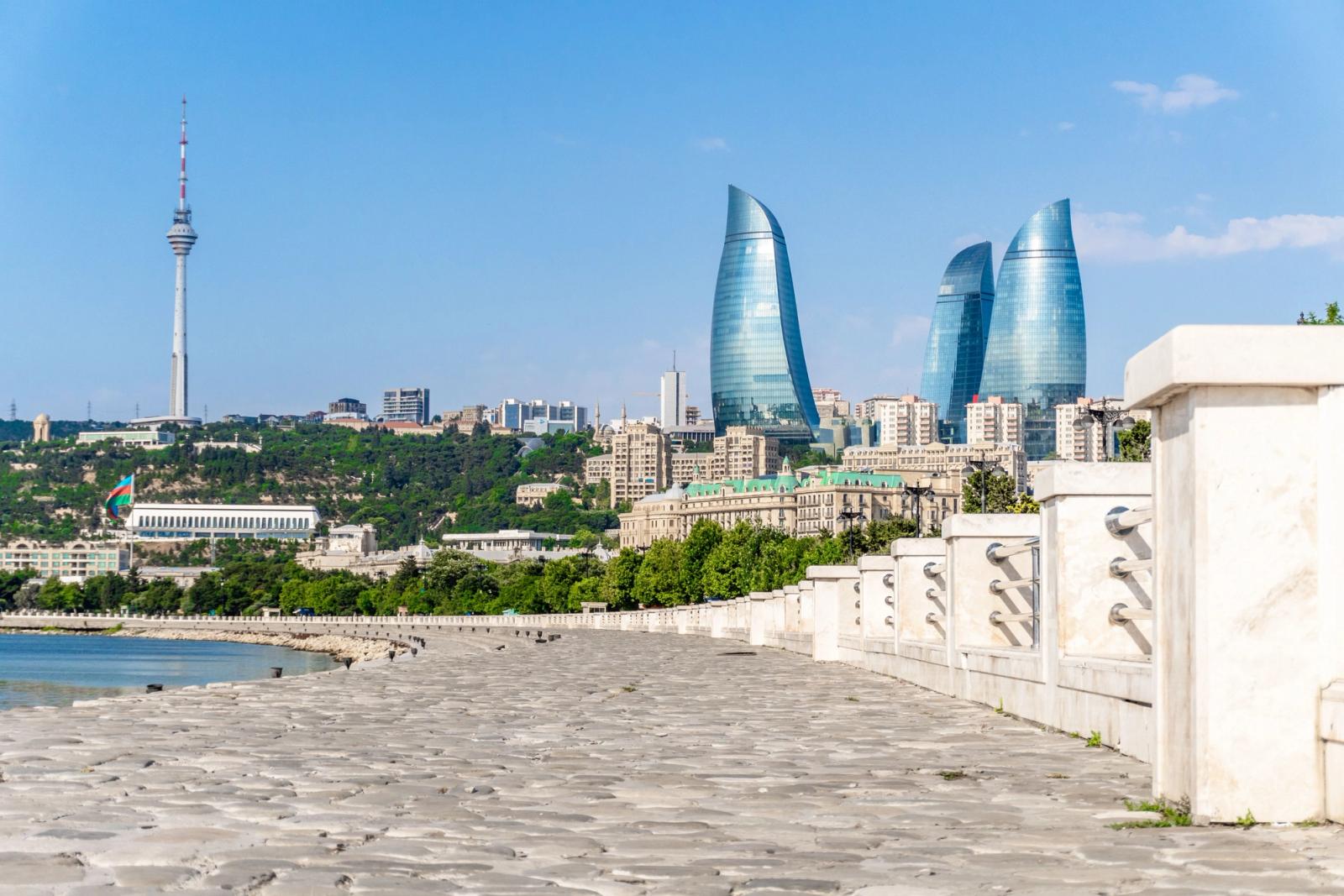 Vibrant view of Baku's skyline featuring the iconic Flame Towers and Caspian Sea coast