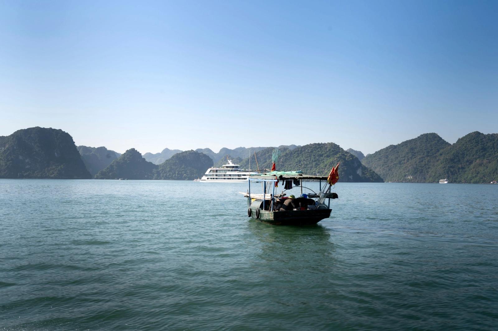 Traditional boat on Halong Bay with scenic islands in Vietnam