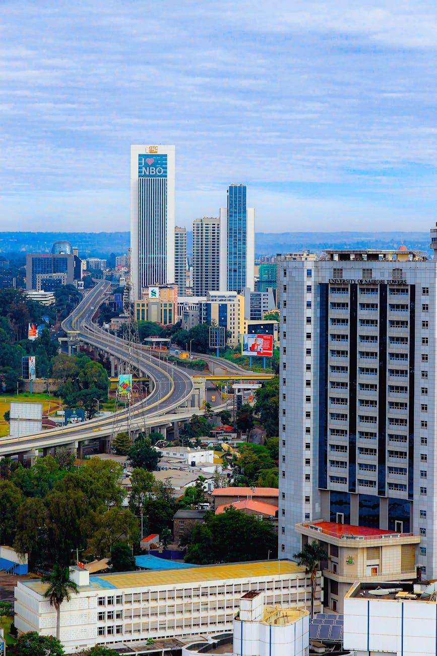 Aerial view of Nairobi's modern skyline featuring winding highways and iconic skyscrapers