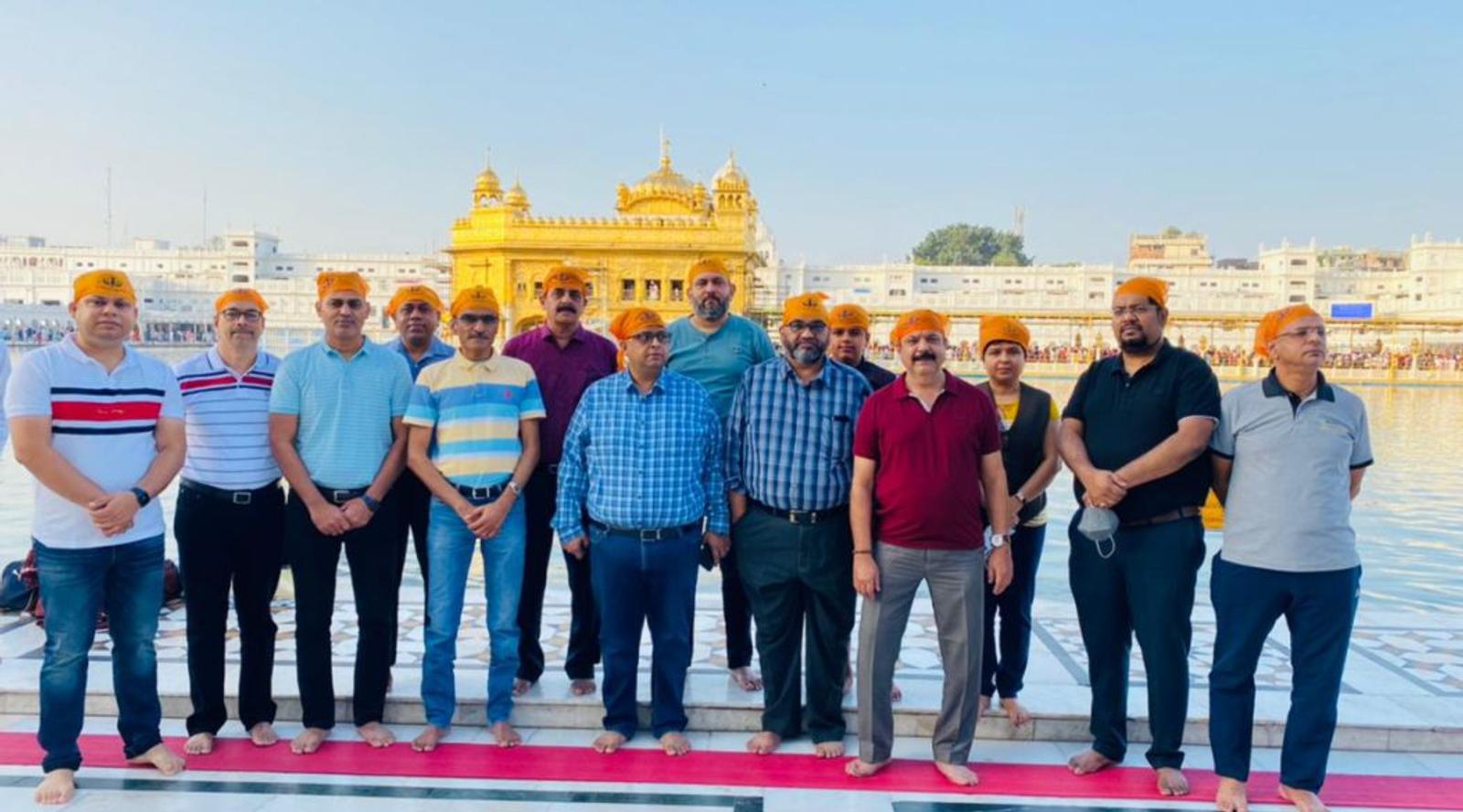 A group of people posing at the Golden Temple, Amritsar.