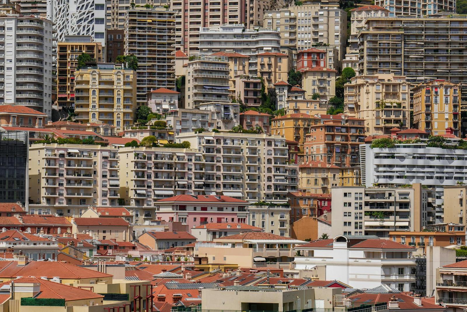 Tightly packed apartment buildings covering a steep hillside city