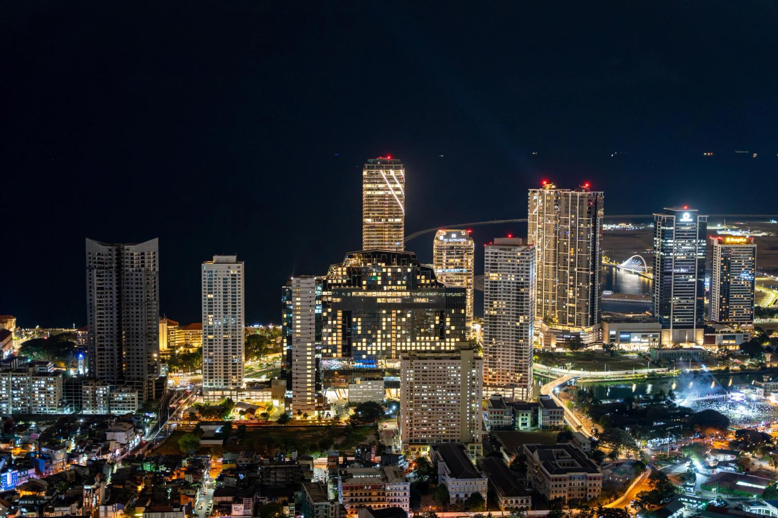 Stunning aerial view of Colombo's vibrant cityscape at night with illuminated skyscrapers