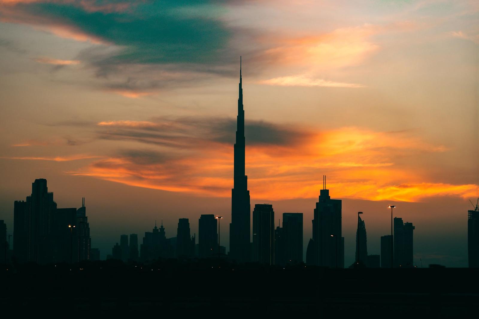 Silhouette of Dubai's skyline with Burj Khalifa at sunset, creating a stunning cityscape
