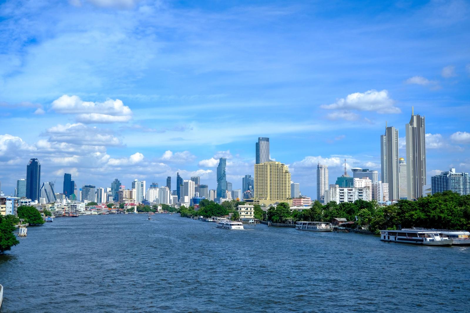 Vibrant Bangkok city skyline with Chao Phraya River, showcasing a mix of modern architecture and nature