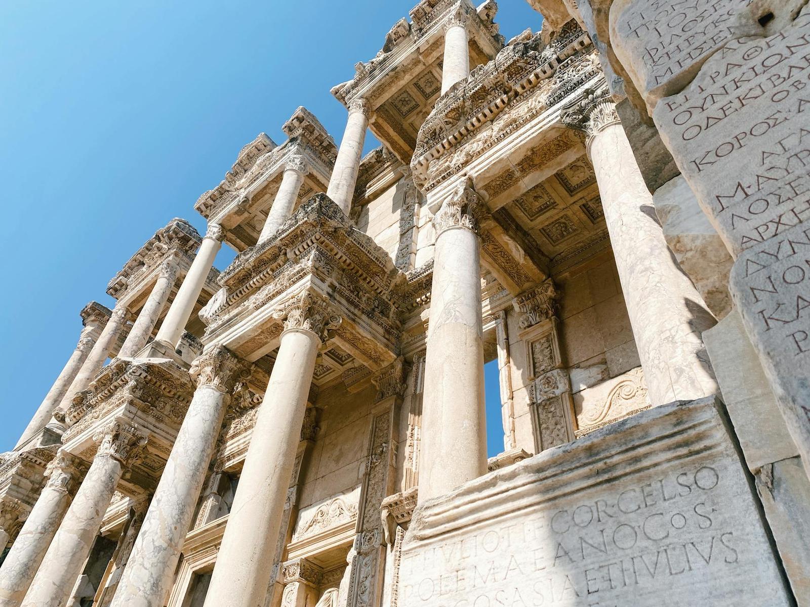 Ornate carved facade of an ancient library with tiered classical columns