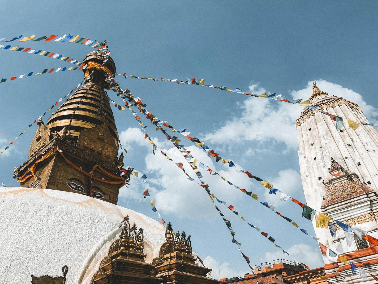 Swayambhunath Stupa and colorful prayer flags under a clear blue sky in Kathmandu, Nepal
