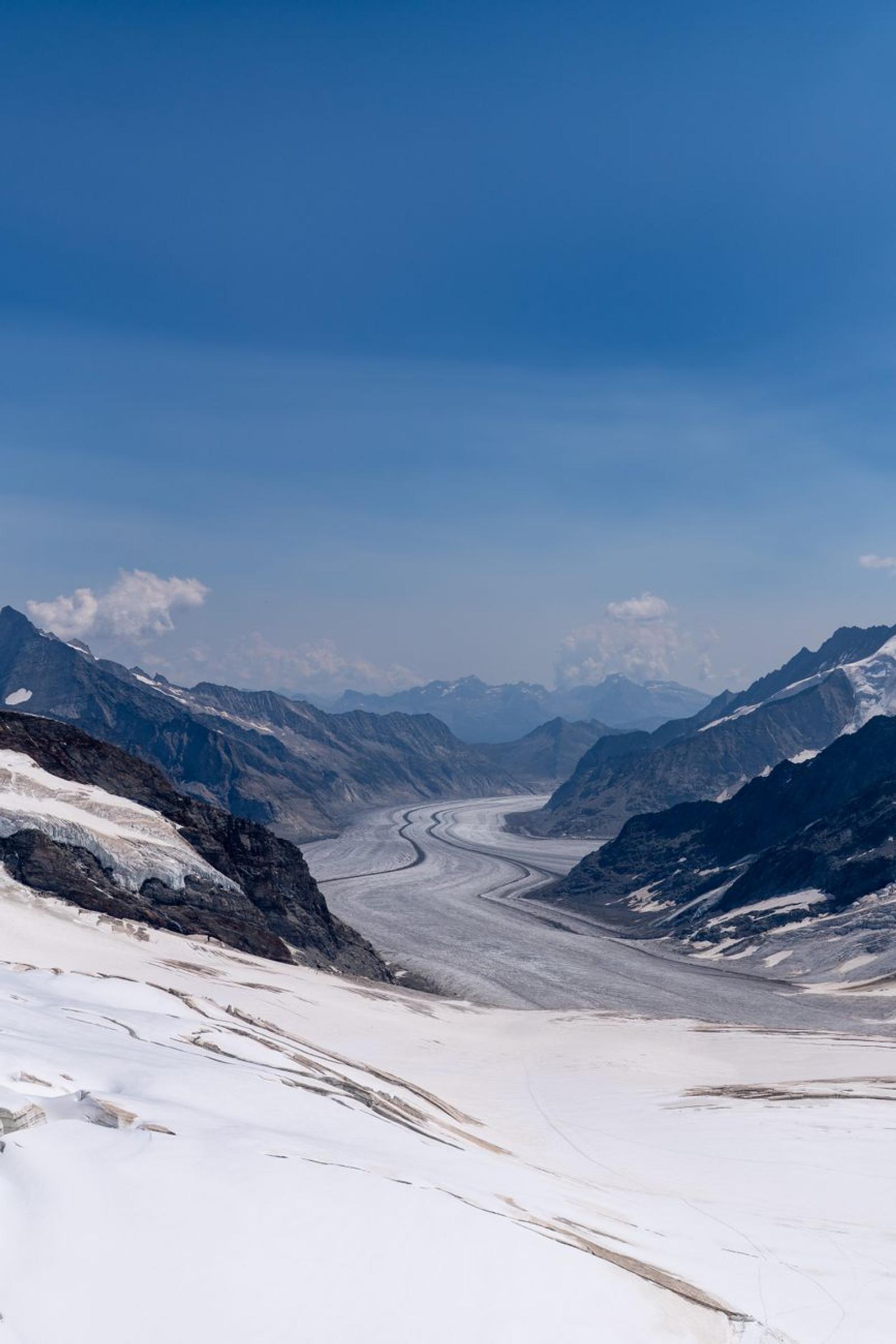 Majestic panoramic view of the Aletsch Glacier in the Swiss Alps with clear blue skies