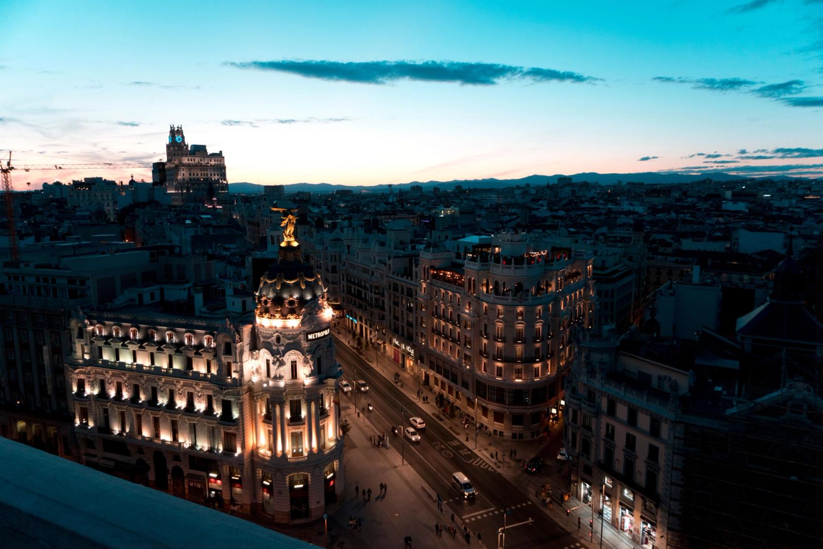 A stunning view of Madrid cityscape during twilight with beautifully illuminated buildings and clear skies