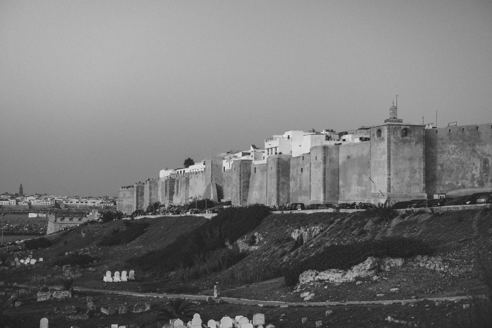 Black and white photo of historic city walls in Rabat, Morocco, showcasing ancient architecture