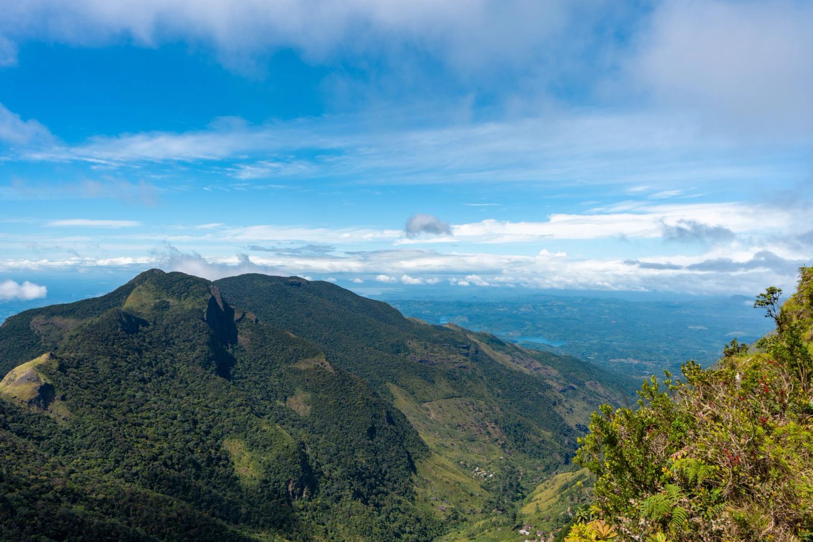 A stunning view of the lush mountainous landscape in Central Province, Sri Lanka, under a clear blue sky