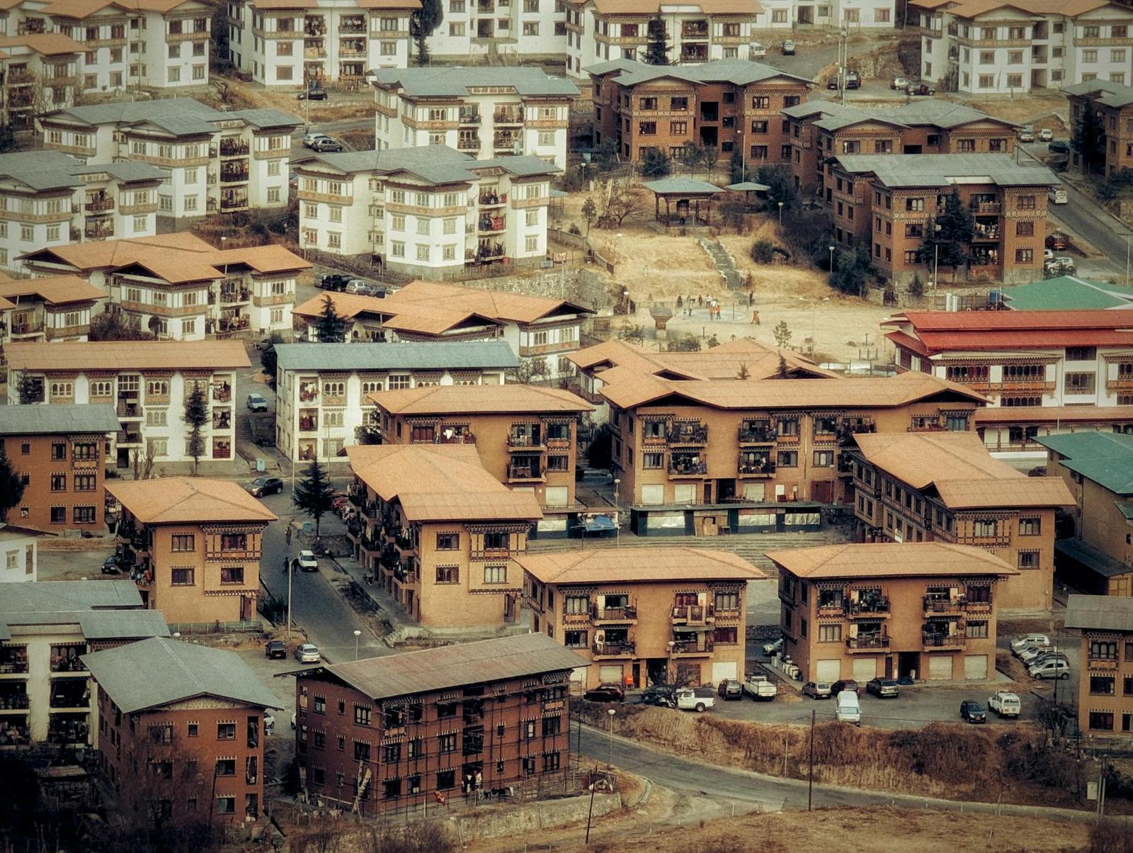 Aerial view of a densely packed town of red-roofed traditional buildings