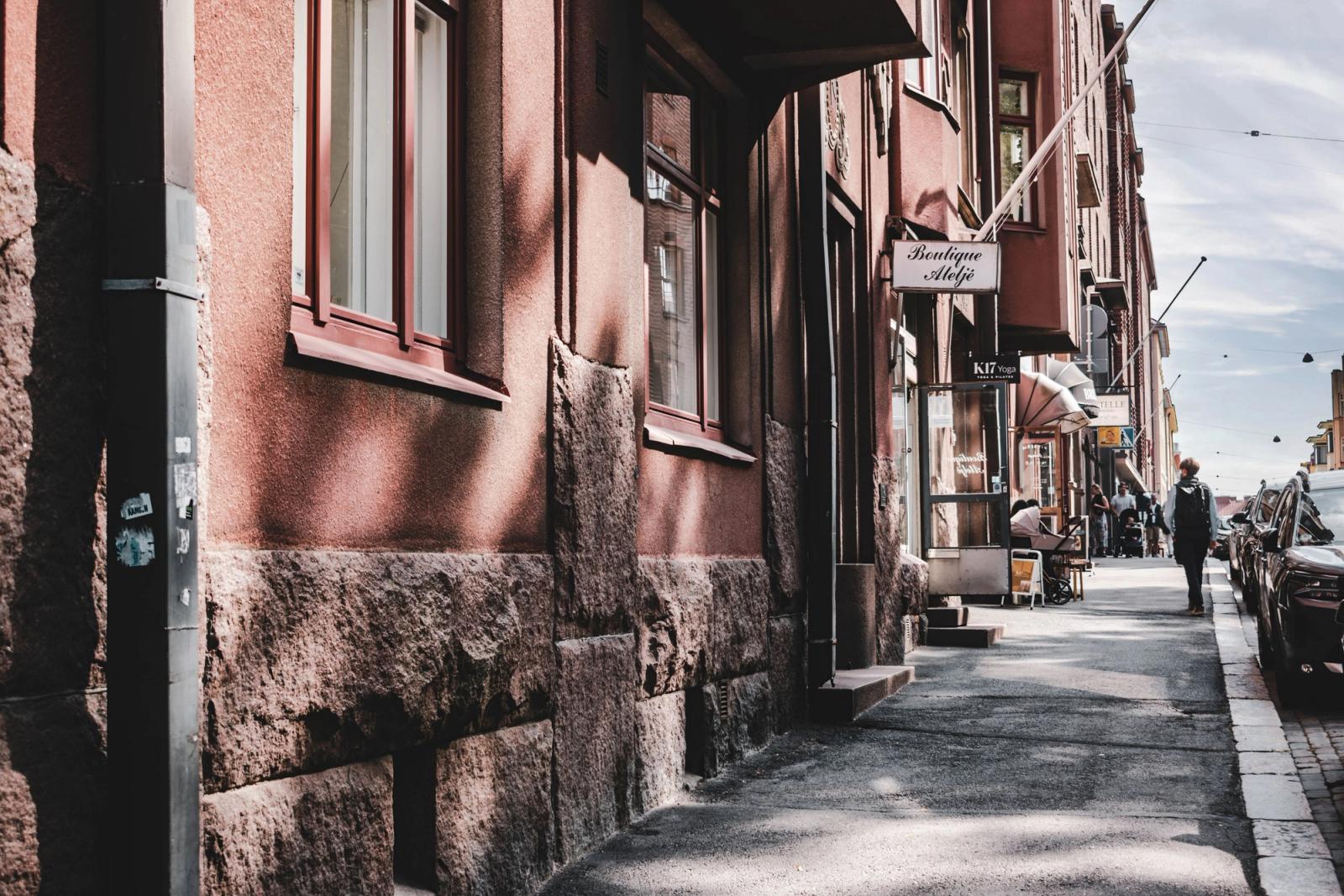 Explore a quaint Helsinki street featuring a boutique and classic architecture