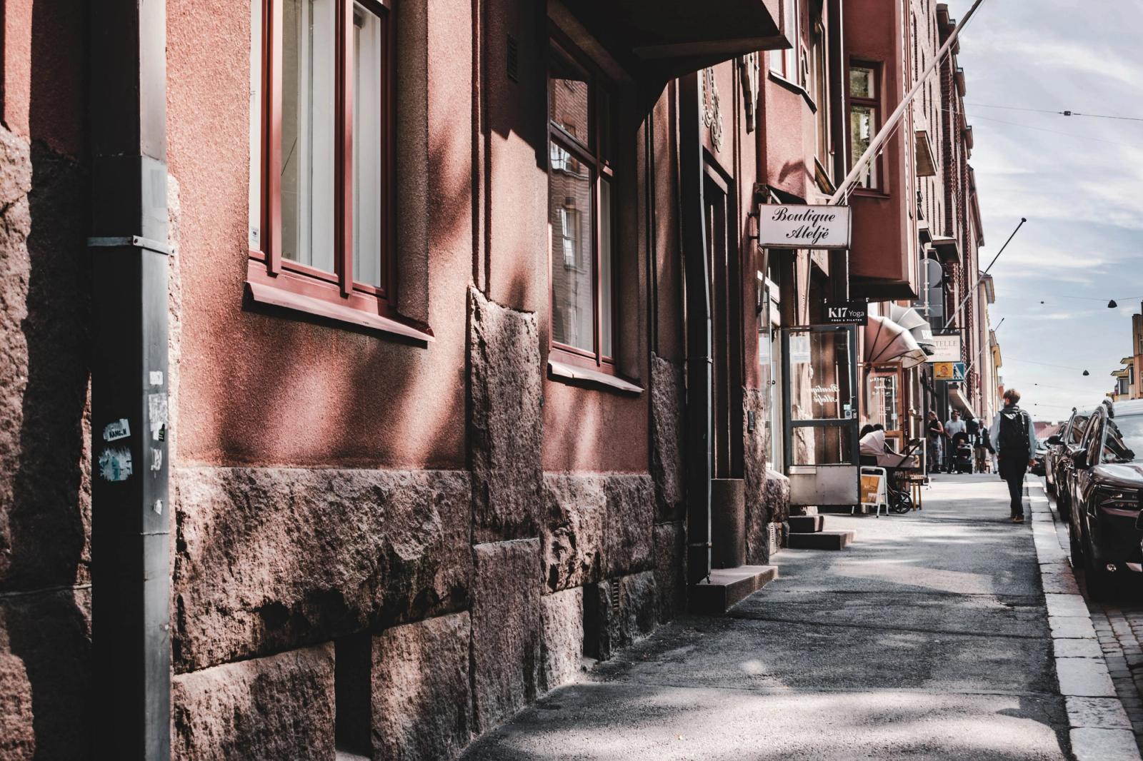 Explore a quaint Helsinki street featuring a boutique and classic architecture