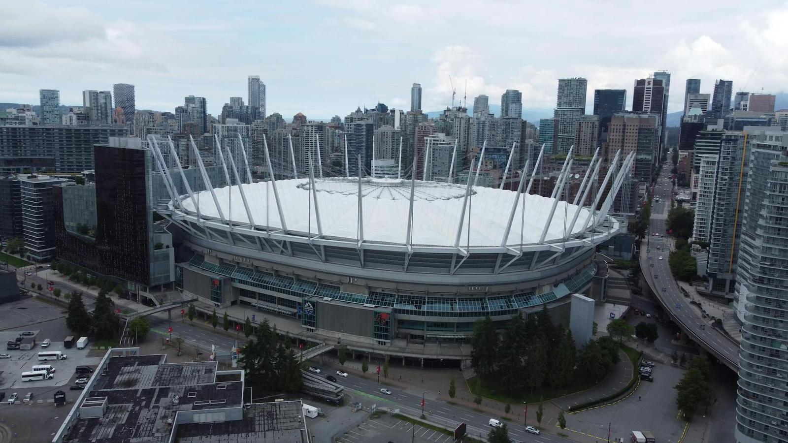 Aerial view of a domed stadium surrounded by a city skyline