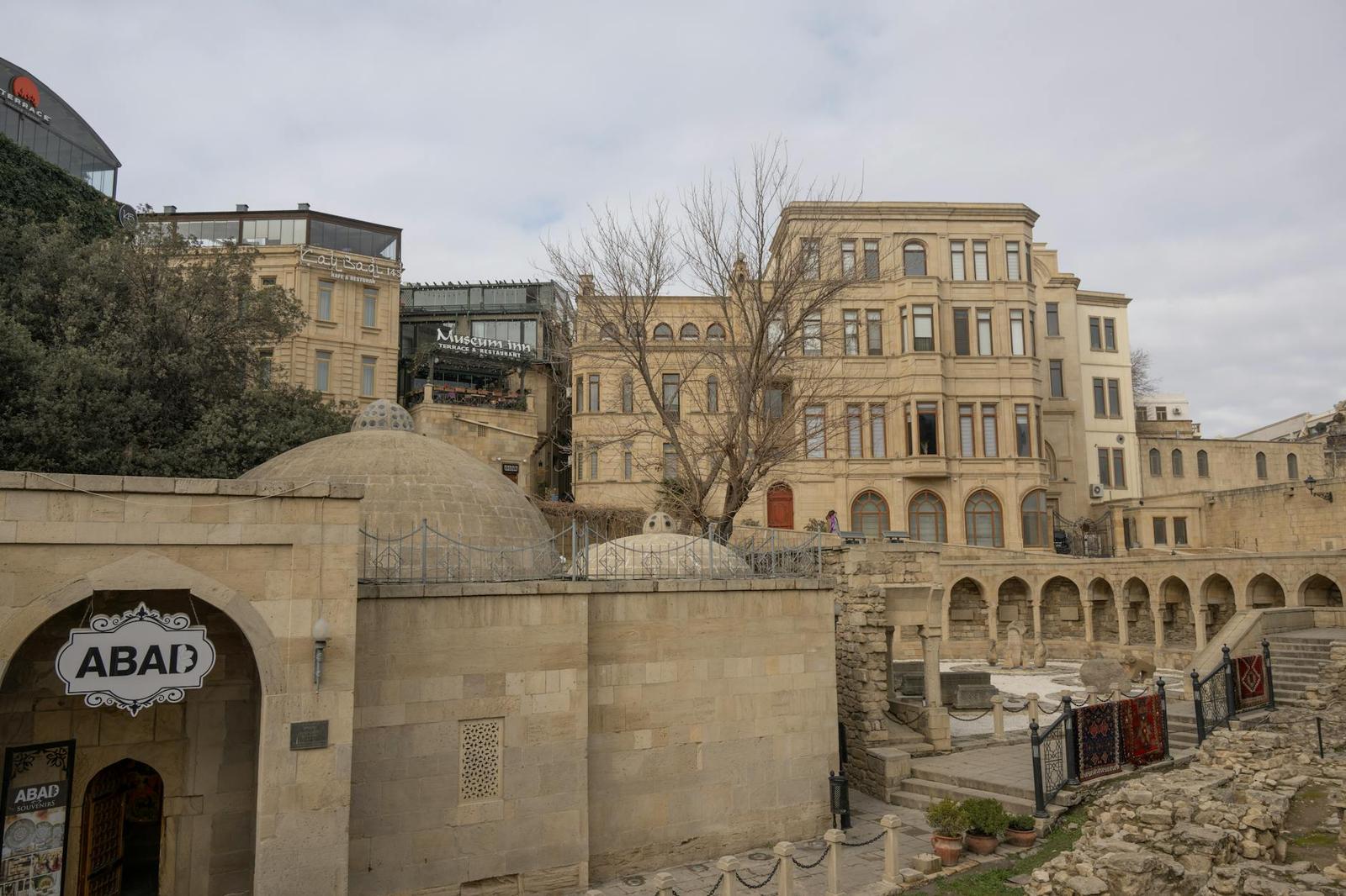 Domed stone buildings cluster along an old-town street corner