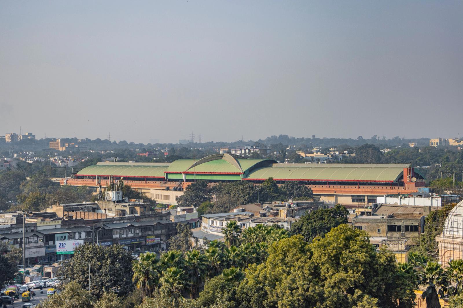 Panoramic aerial view of Pragati Maidan showcasing New Delhi's urban skyline under clear skies