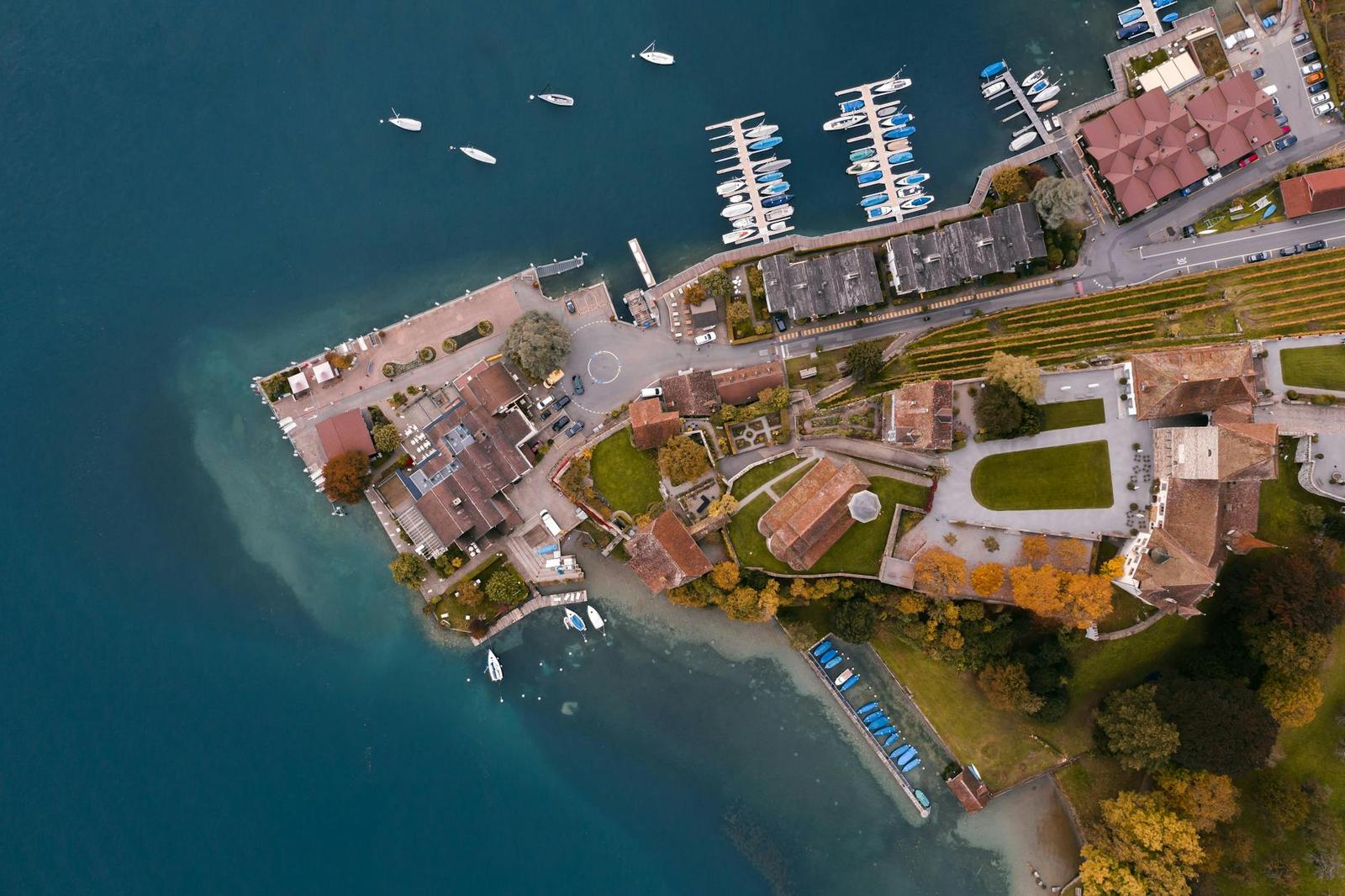 Aerial view of a lakeside marina and resort peninsula with moored boats