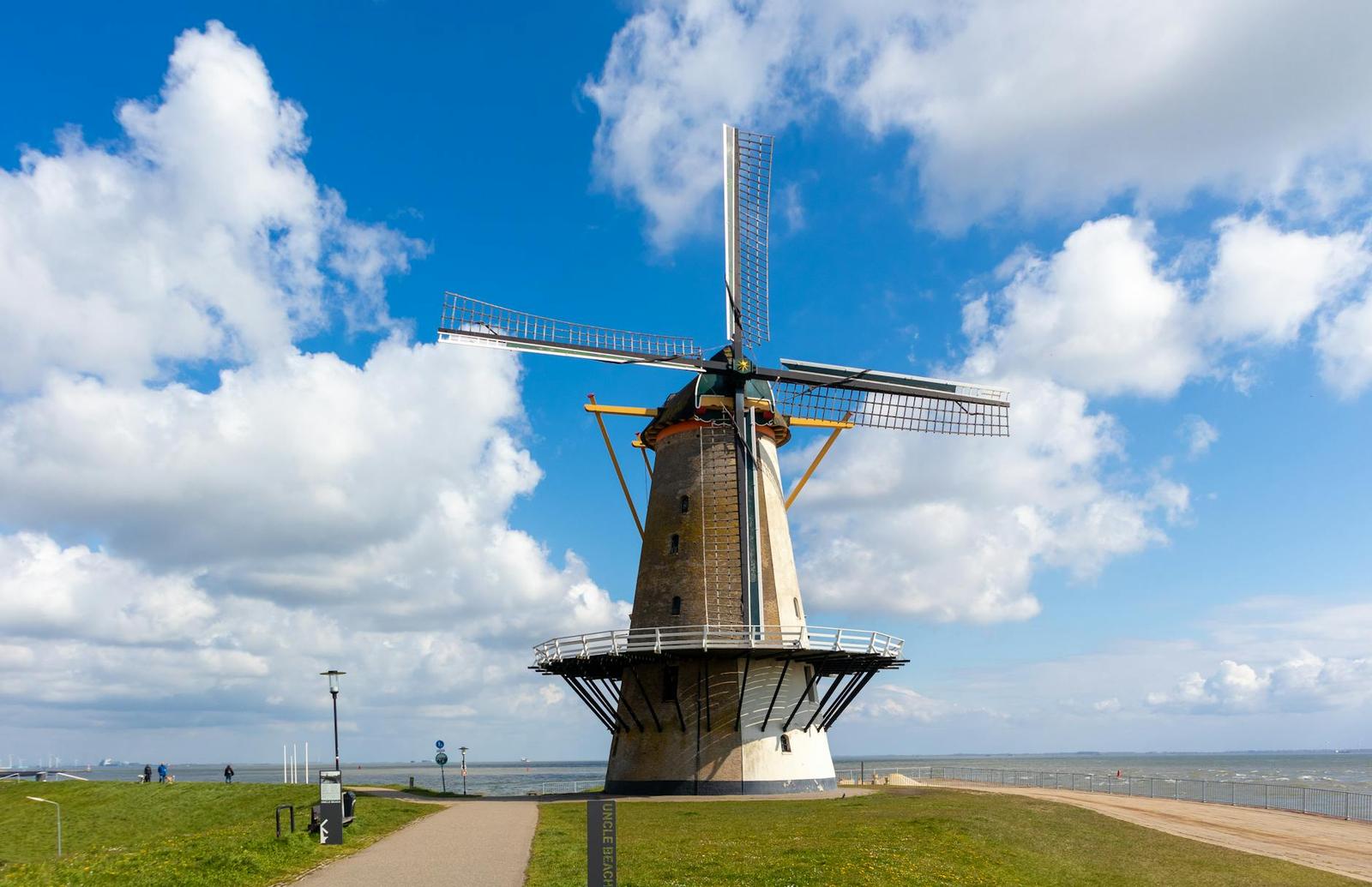 Classic windmill on a sunny day in Vlissingen, Netherlands, near the sea with blue skies
