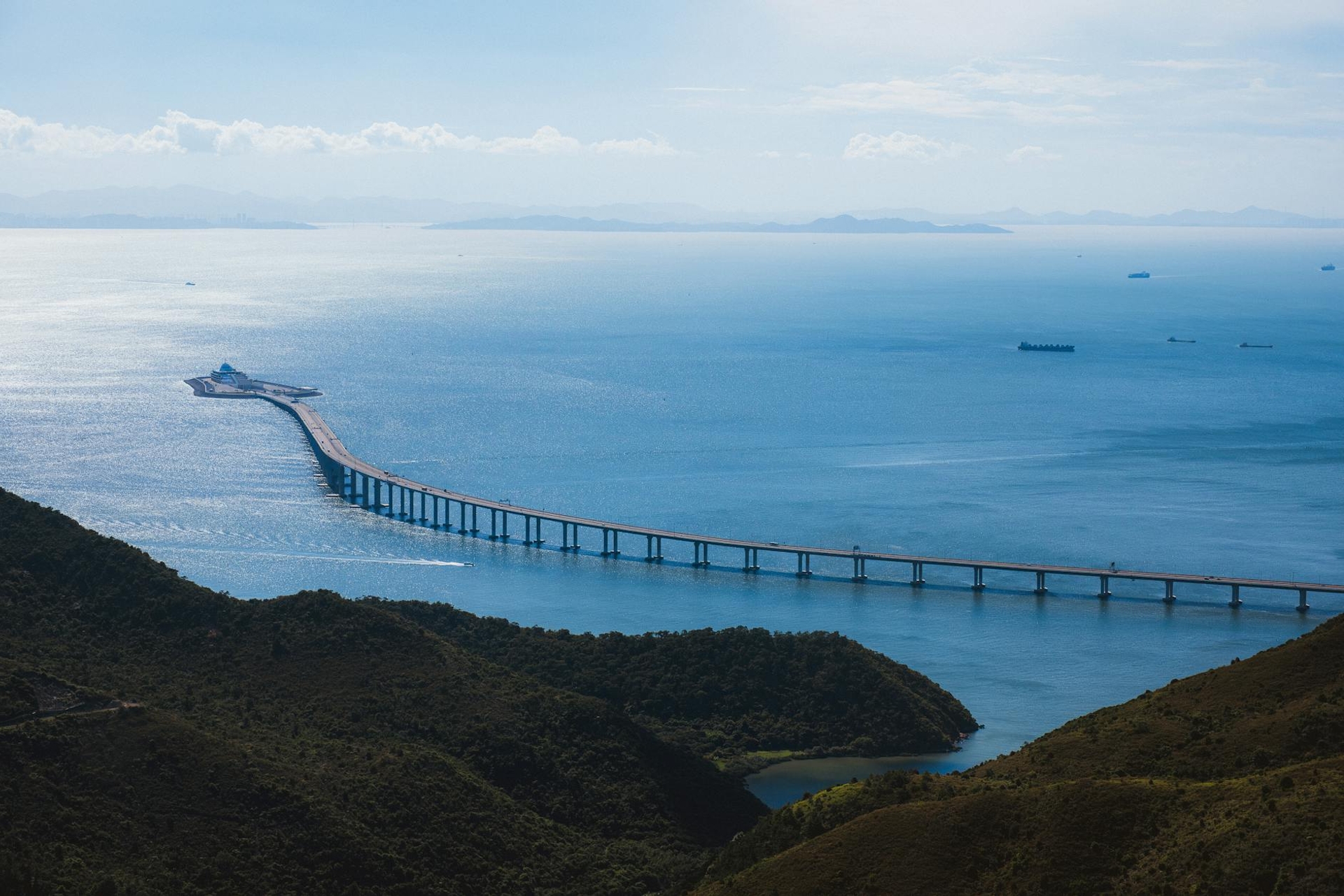 A long sea bridge stretching across calm blue water