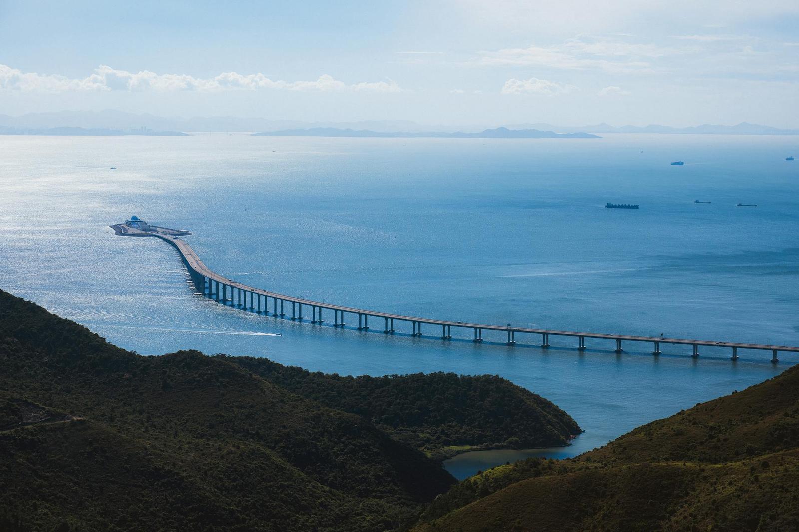 A long sea bridge stretching across calm blue water